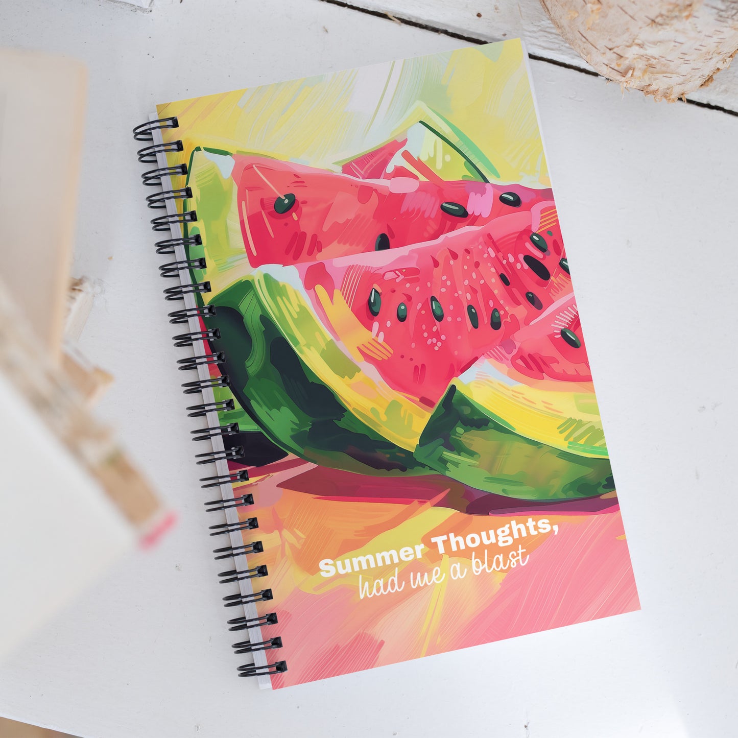 Spiral notebook with colorful watermelon design and text 'Summer Thoughts, had me a blast' on a white surface