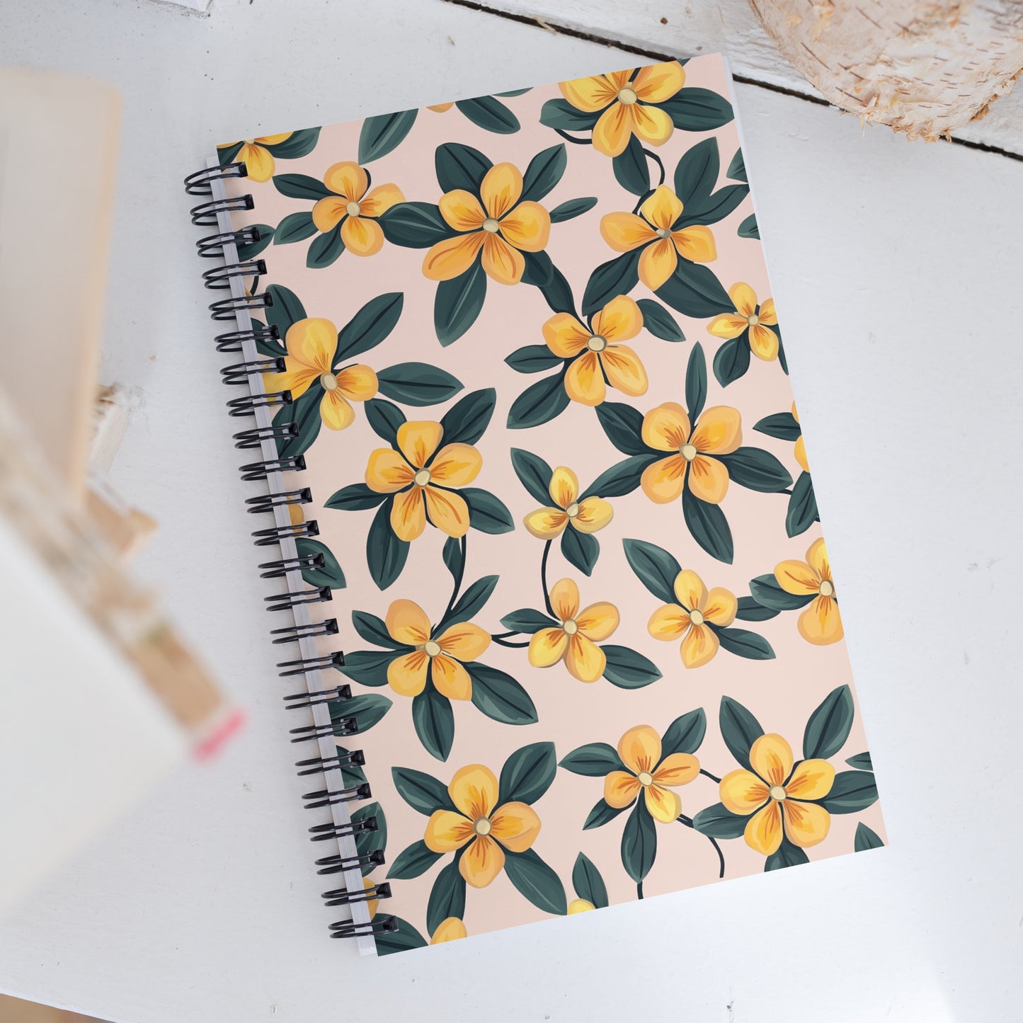 A5 spiral dotted notebook featuring a beautiful yellow and dark blue periwinkle floral pattern on a silky soft-touch cover.