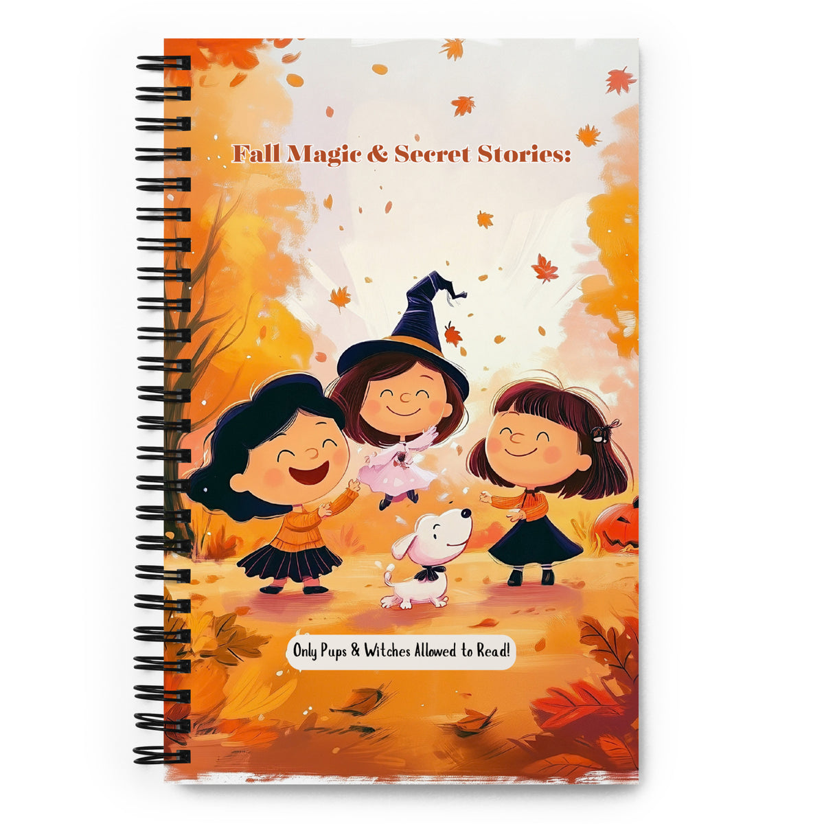 A spiral-bound notebook with a colorful autumn cover illustration featuring three children in witch costumes, falling leaves, and the title 'Fall Magic & Secret Stories!'.