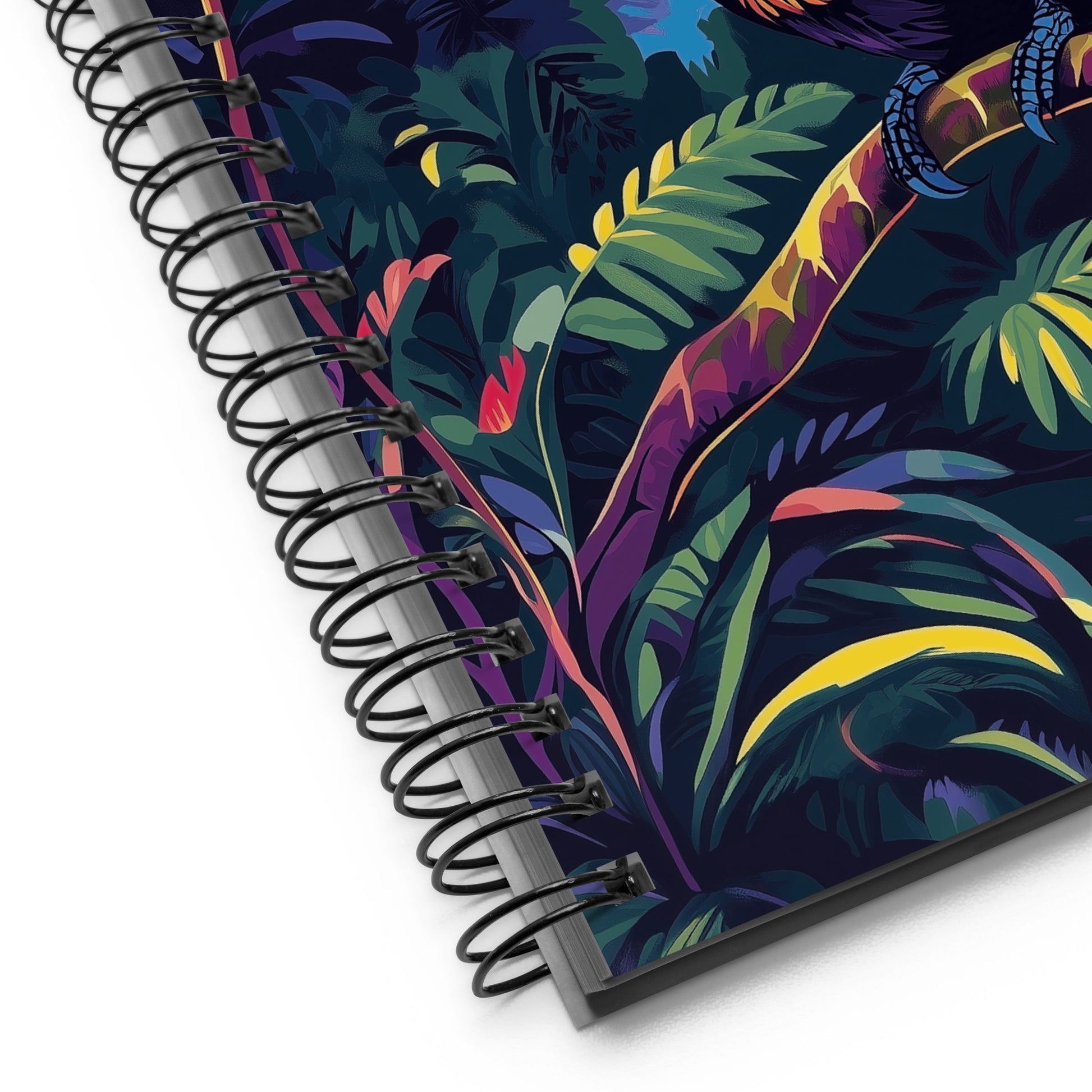 Spiral-bound notebook with a colorful tropical leaf design on a white background. 