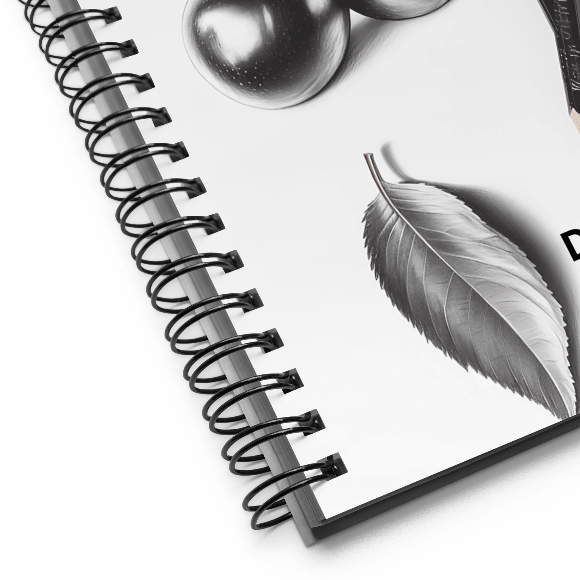 Spiral-bound notebook with a detailed pencil drawing of a leaf and fruit on a white background. 