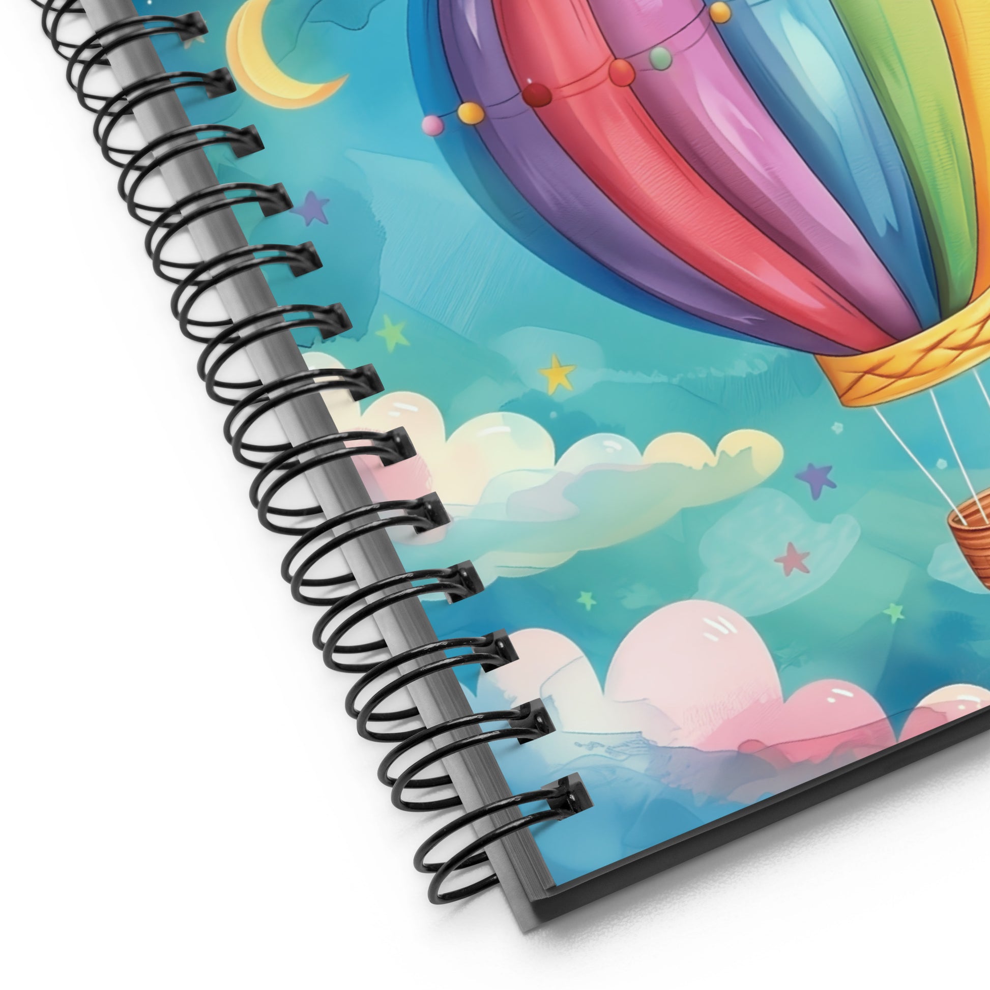 Close up of spiral notebook with a colorful hot air balloon design on the cover by  Sweet and Savage. 