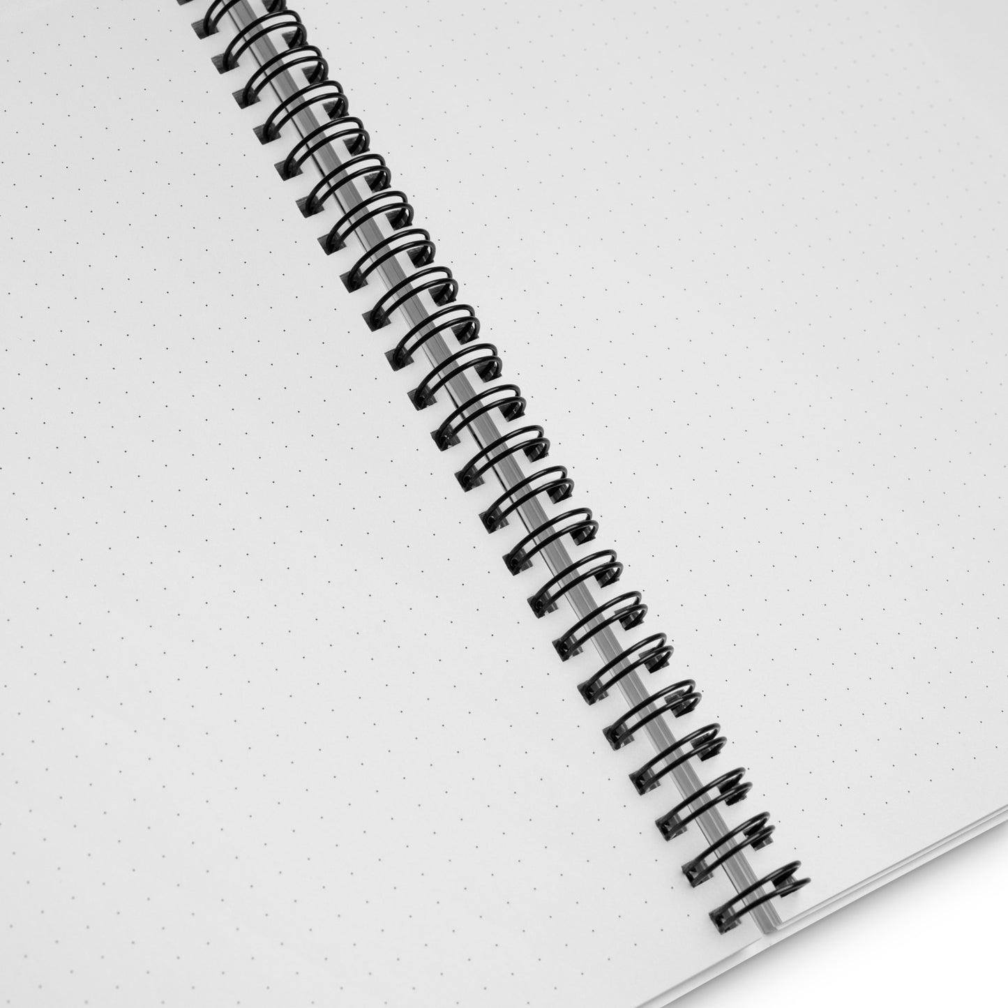 Spiral-bound notebook with dotted pages on a white background. 
