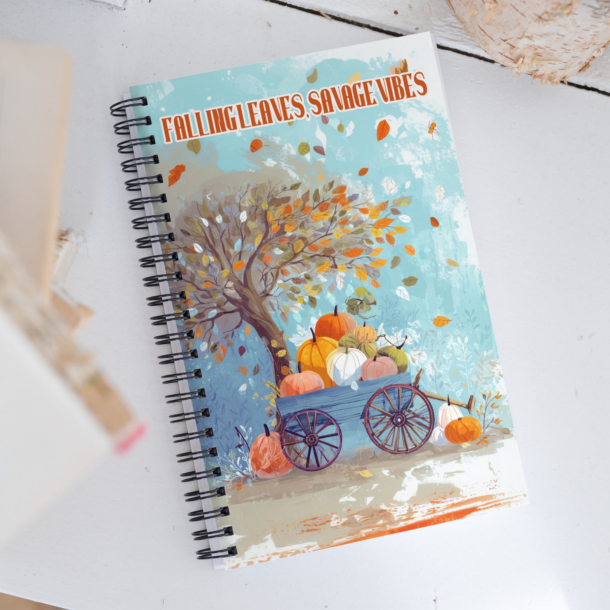 Notebook with autumn themed cover featuring pumpkins and a cart, titled 'Falling Leaves Savage Vibes', by Sweet and Savage. 
