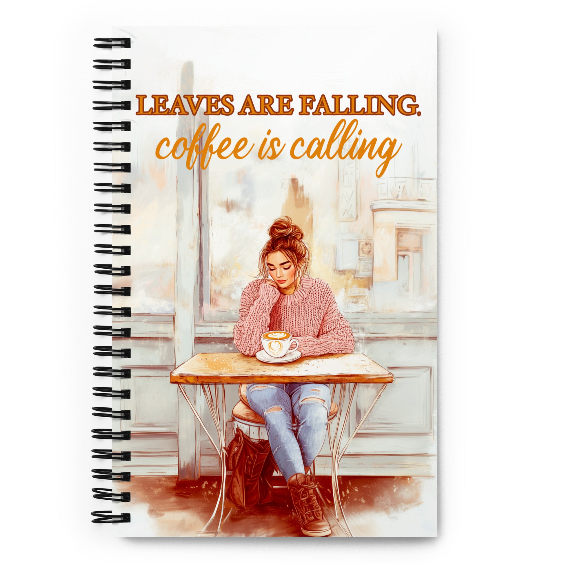 Spiral notebook with 'Leaves Are Falling, Coffee Is Calling' autumn illustration. Mockup shows a girl in a pink sweater at a café. Premium stationery for journaling and sketching.