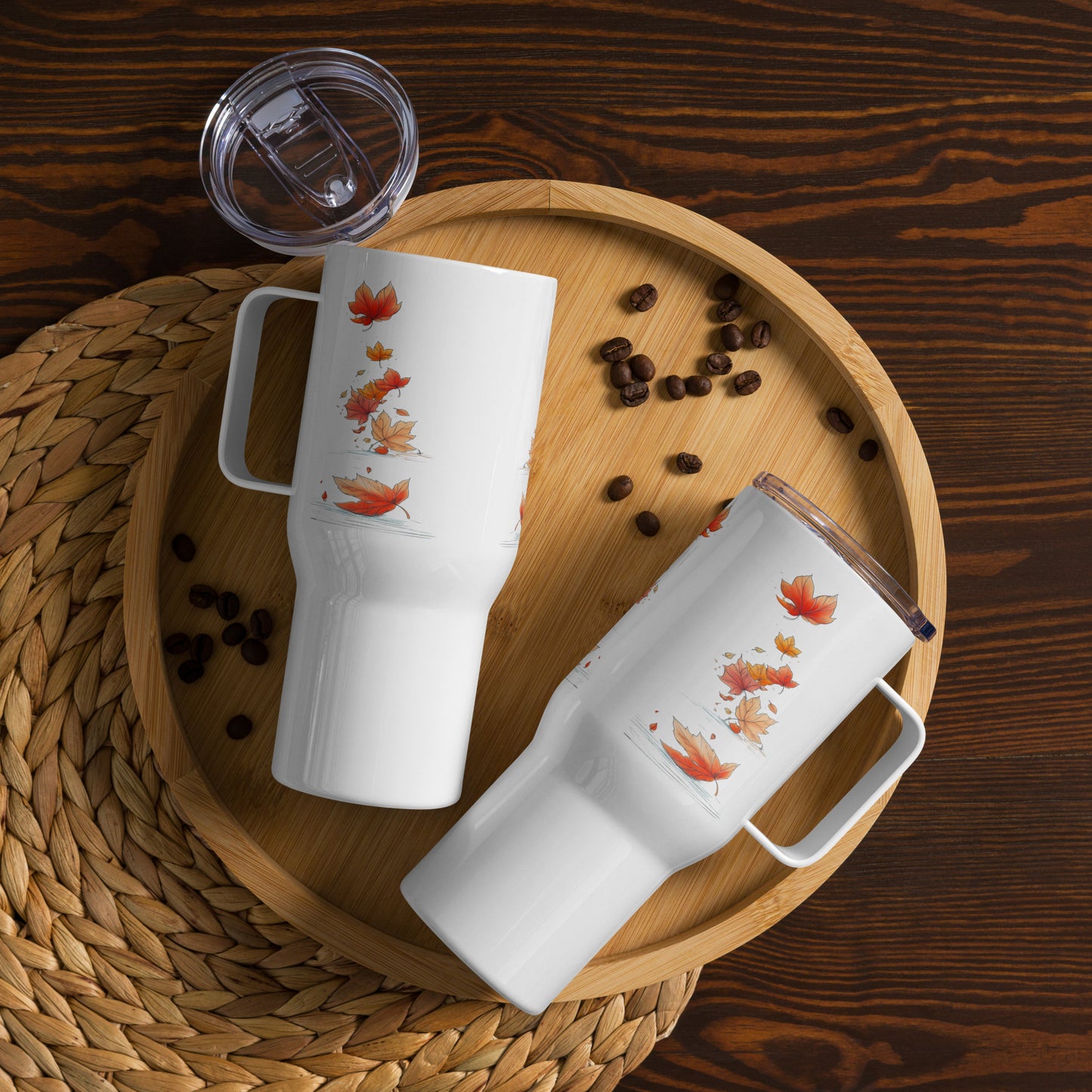 Two white mugs with red patterns on a wooden tray with coffee beans.