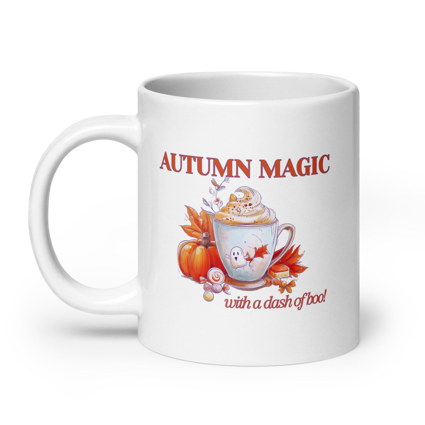 A white ceramic mug featuring an autumn-themed graphic with the text 'AUTUMN MAGIC with a dash of boo!'. The design includes a hot cocoa cup with whipped cream, a small ghost, a pumpkin, and falling leaves in warm orange, red, and brown tones.