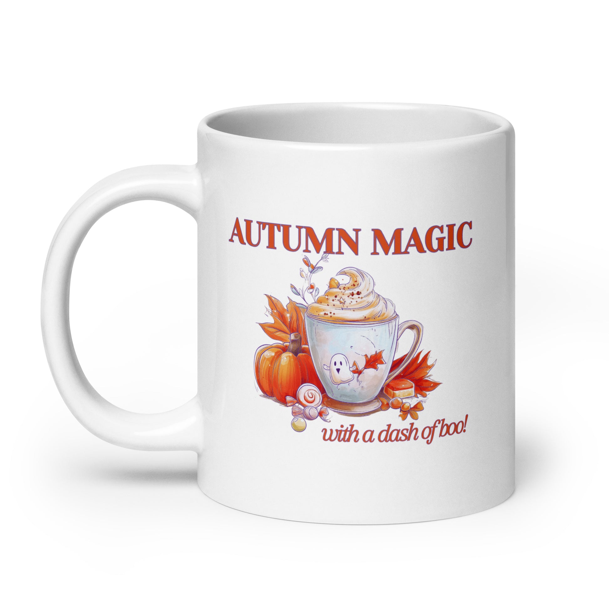 A white ceramic mug featuring an autumn-themed graphic with the text 'AUTUMN MAGIC with a dash of boo!'. The design includes a hot cocoa cup with whipped cream, a small ghost, a pumpkin, and falling leaves in warm orange, red, and brown tones.